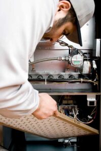 HVAC technician working on an air conditioning unit